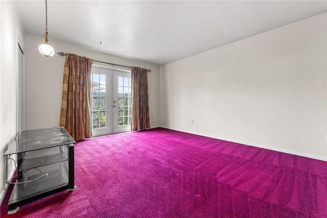 empty room featuring carpet flooring and french doors