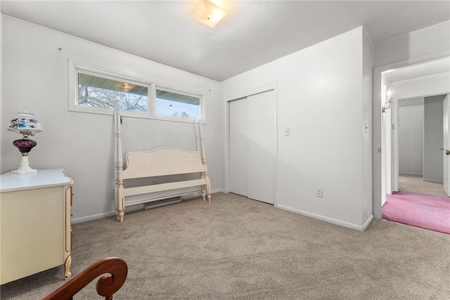 unfurnished bedroom featuring light colored carpet and a closet