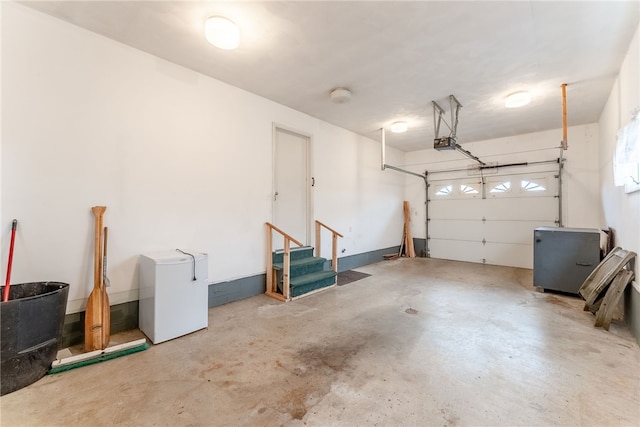 garage featuring refrigerator and a garage door opener