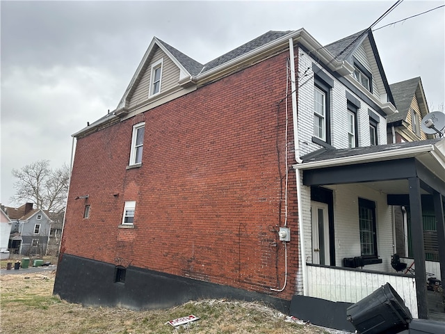 view of side of home with a porch