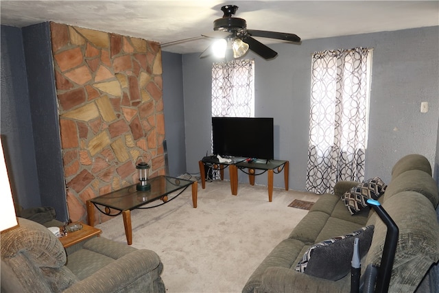 carpeted living room with ceiling fan