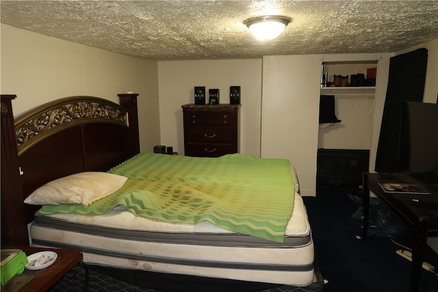 bedroom featuring a textured ceiling and a closet