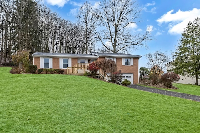 view of front of home with a front lawn and a garage