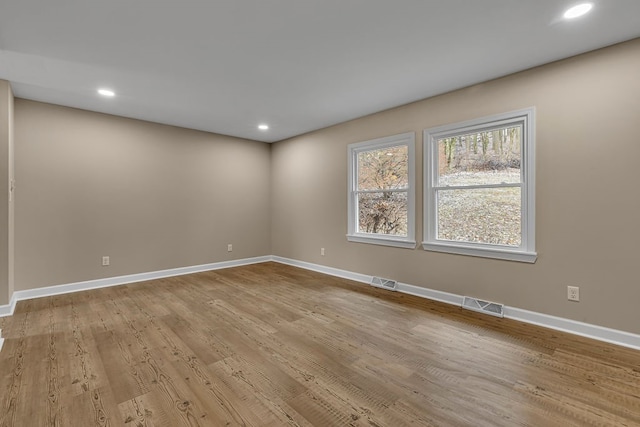 spare room with light hardwood / wood-style floors