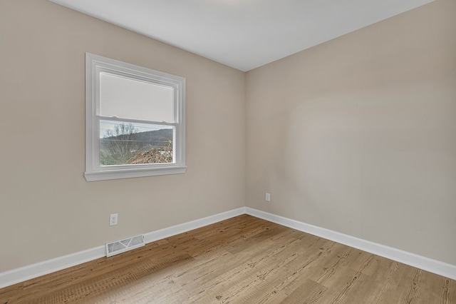 spare room with light hardwood / wood-style floors