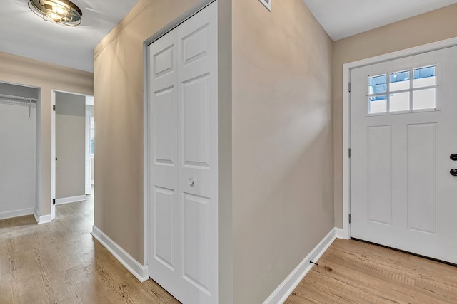 foyer entrance with light hardwood / wood-style floors