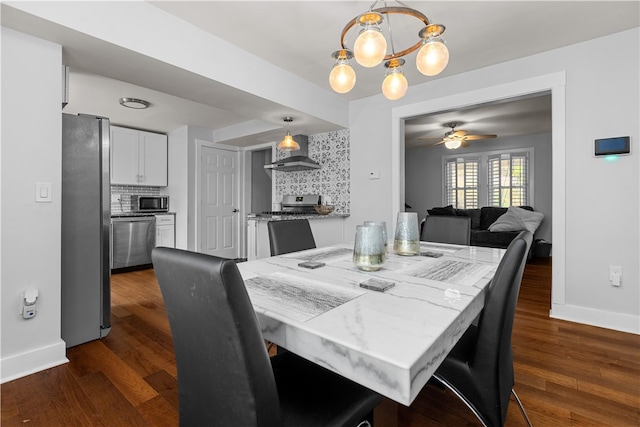 dining area featuring ceiling fan with notable chandelier and dark hardwood / wood-style flooring