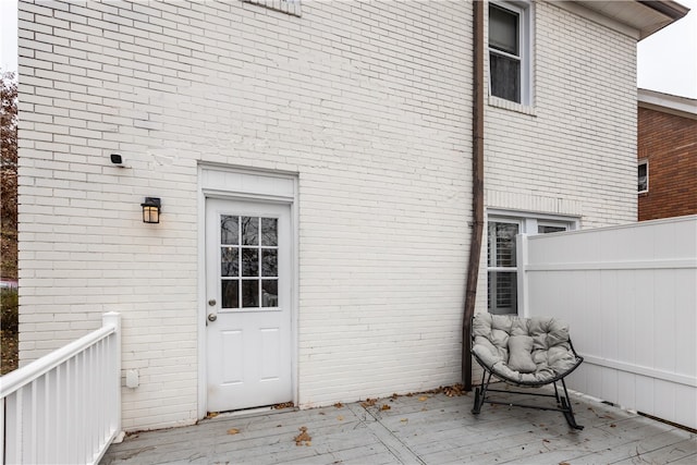 view of exterior entry featuring a wooden deck