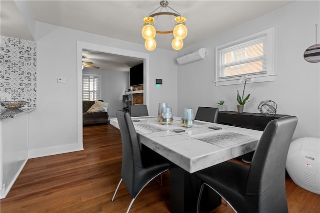 dining space featuring a wall mounted AC, ceiling fan with notable chandelier, and dark hardwood / wood-style floors