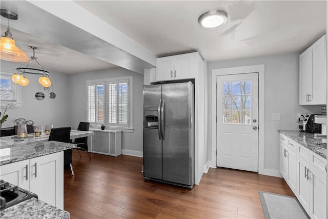 kitchen with white cabinets, stainless steel fridge with ice dispenser, dark hardwood / wood-style flooring, and decorative light fixtures