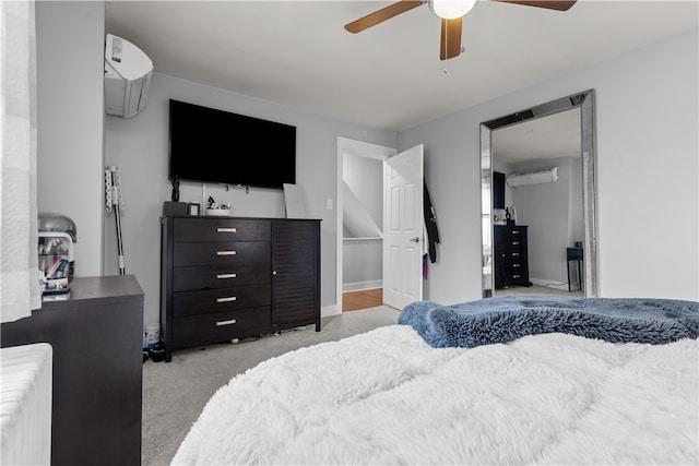 bedroom featuring ceiling fan, light carpet, radiator, and a wall mounted AC