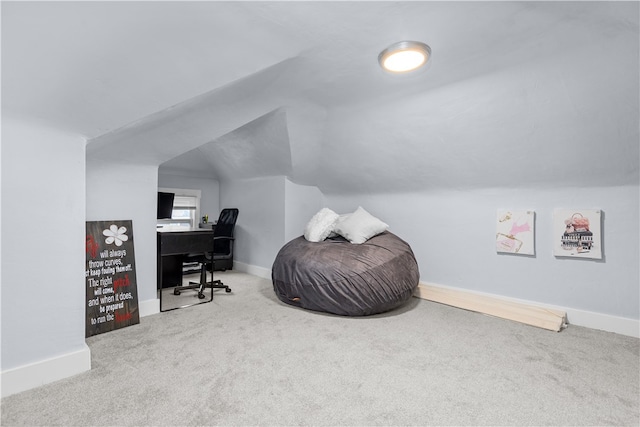 carpeted office with lofted ceiling