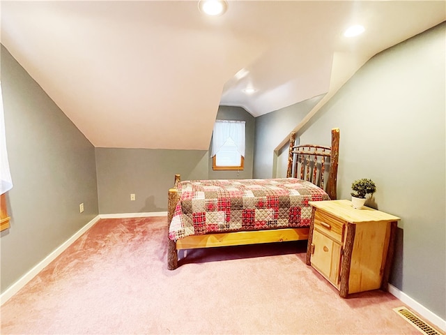 carpeted bedroom featuring lofted ceiling