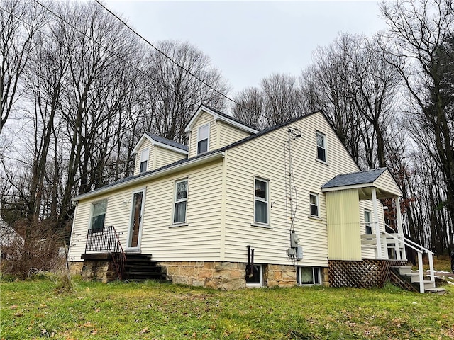 rear view of house featuring a lawn