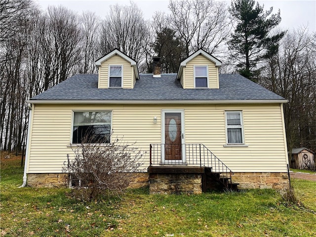 cape cod home with a front lawn