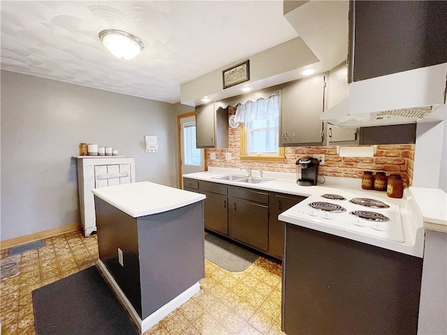 kitchen with exhaust hood, white stovetop, sink, decorative backsplash, and a kitchen island