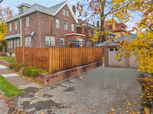 view of side of home with a garage and an outdoor structure