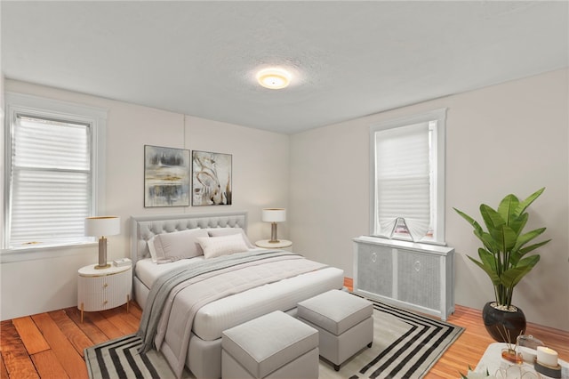 bedroom with hardwood / wood-style flooring and a textured ceiling