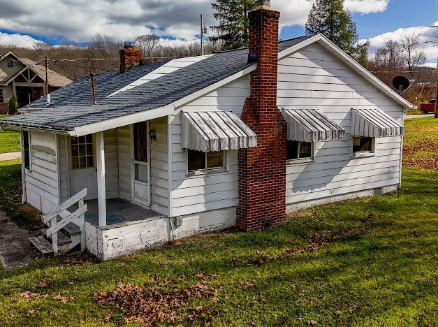 view of property exterior with a yard