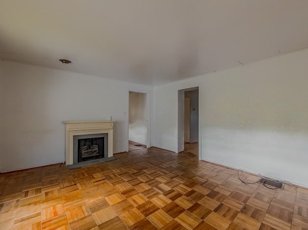 unfurnished living room with light parquet floors