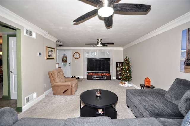 living room featuring ceiling fan, carpet floors, and ornamental molding