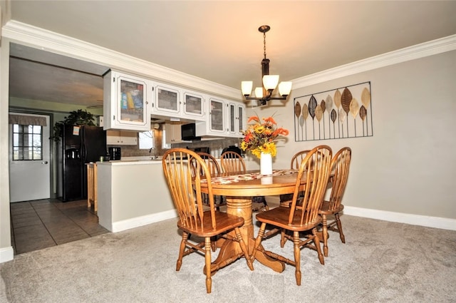 dining space featuring an inviting chandelier, carpet floors, and ornamental molding