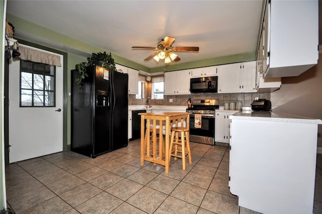 kitchen with ceiling fan, white cabinets, backsplash, light tile patterned flooring, and black appliances