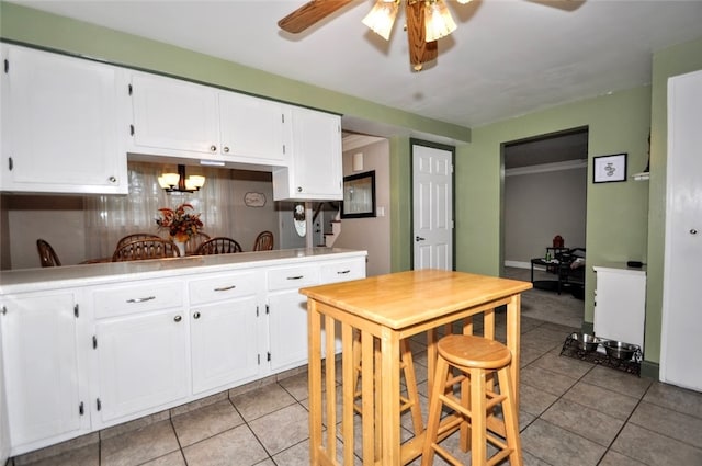 kitchen with white cabinets and light tile patterned floors