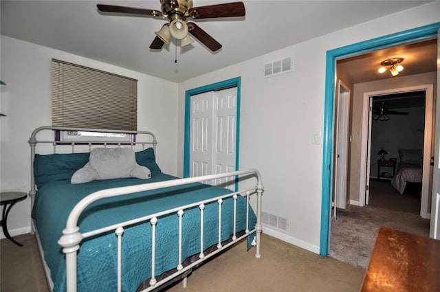 carpeted bedroom with ceiling fan and a closet