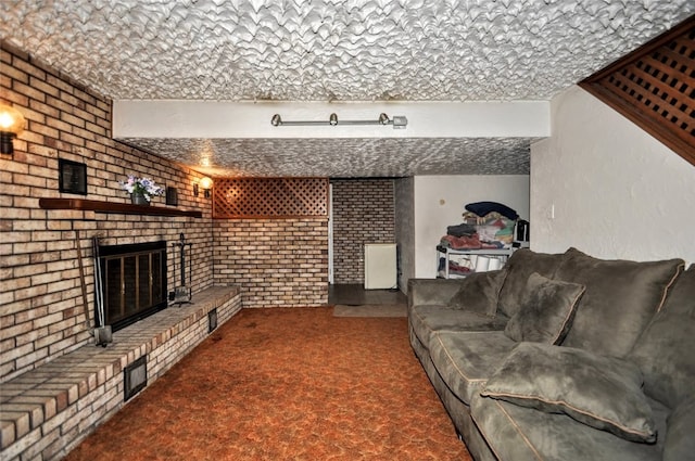 carpeted living room featuring brick wall, a textured ceiling, and a brick fireplace