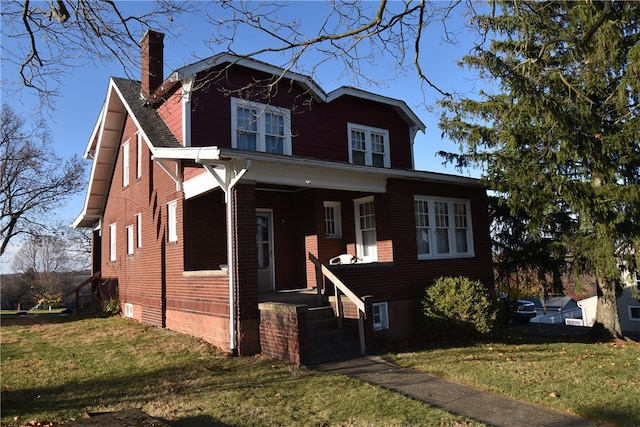 view of front facade with a front yard and a porch