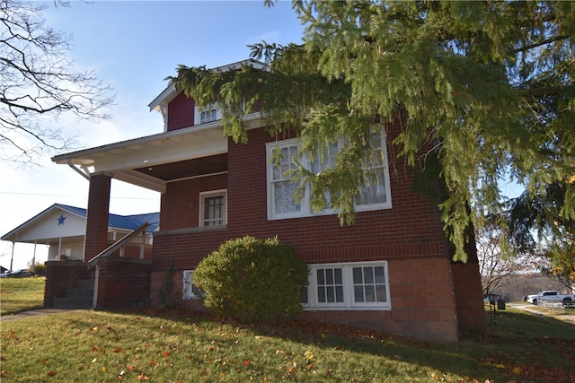 view of property exterior with a porch and a lawn