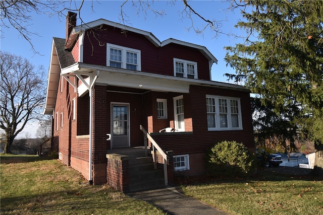 view of front of house featuring covered porch and a front lawn