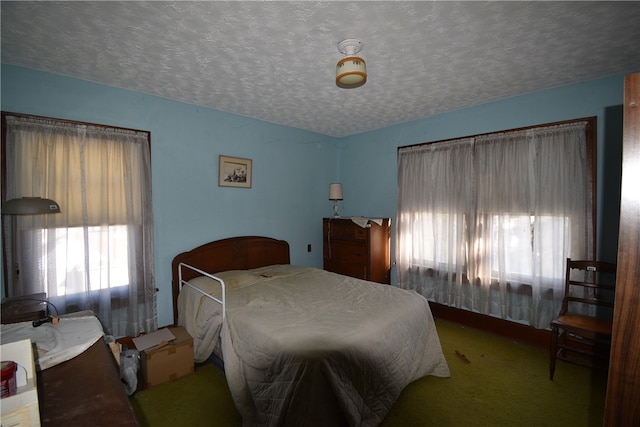 bedroom featuring carpet floors and a textured ceiling