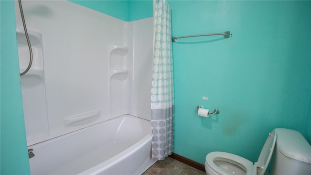 bathroom with toilet and shower / bath combo with shower curtain