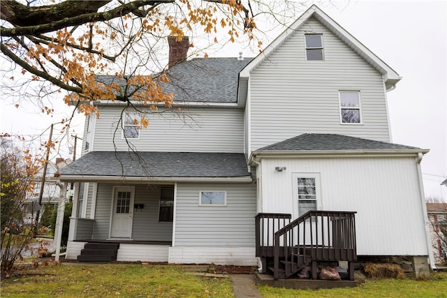 rear view of house with a yard