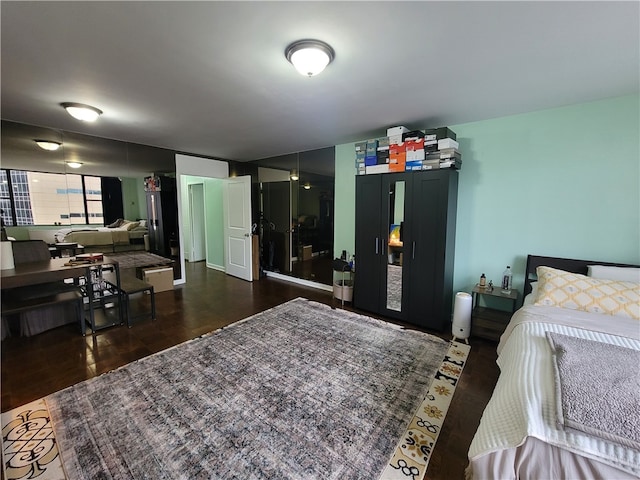 bedroom with dark hardwood / wood-style flooring