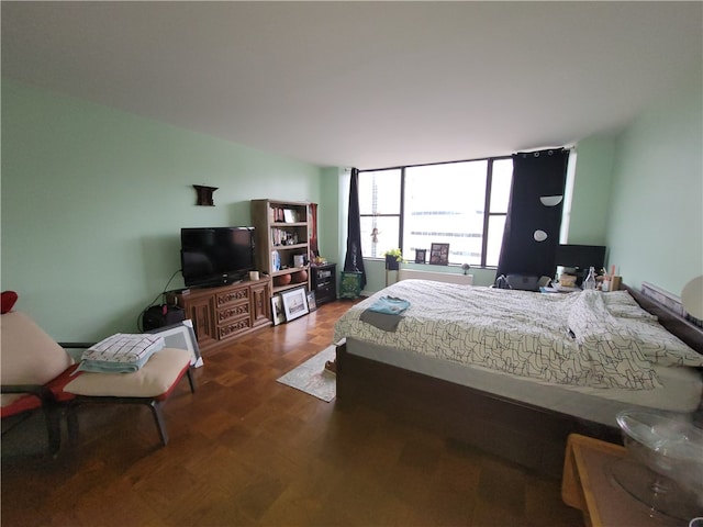 bedroom with dark hardwood / wood-style flooring