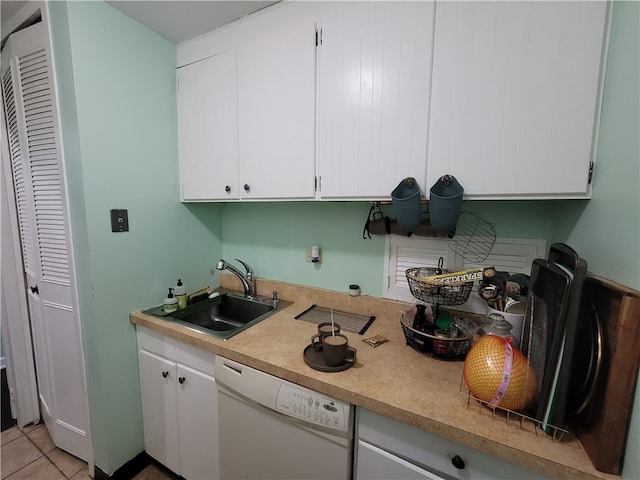 kitchen featuring white cabinets, light tile patterned floors, white dishwasher, and sink