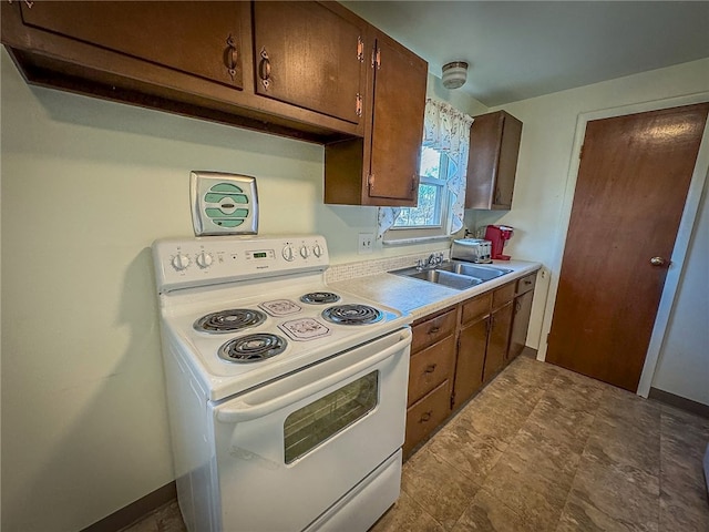 kitchen featuring white electric stove and sink