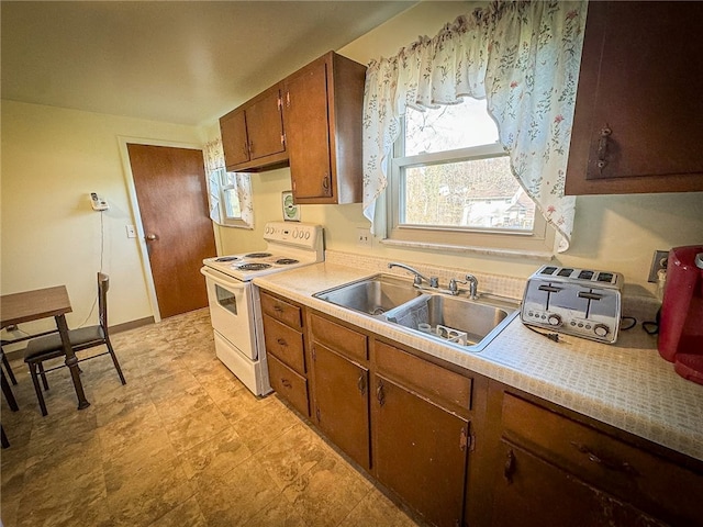 kitchen featuring white electric range and sink