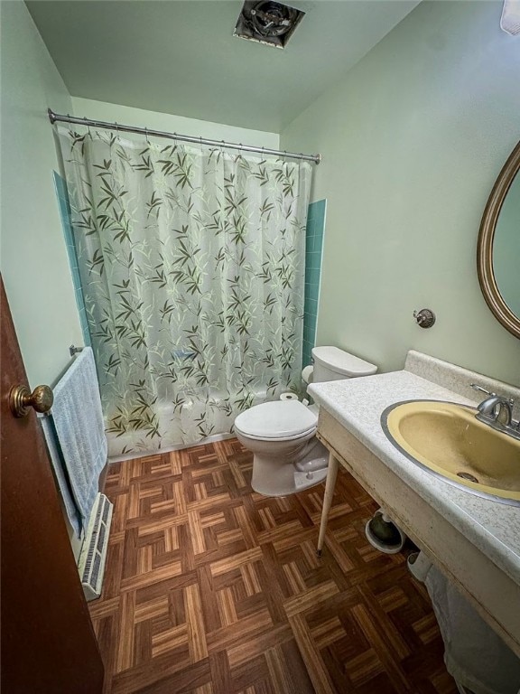 full bathroom featuring toilet, parquet flooring, sink, and shower / tub combo