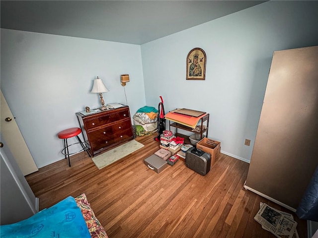 sitting room with dark wood-type flooring