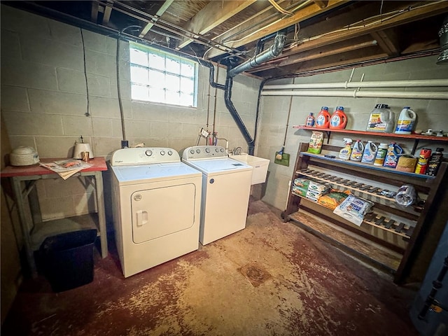 washroom with sink and washing machine and clothes dryer