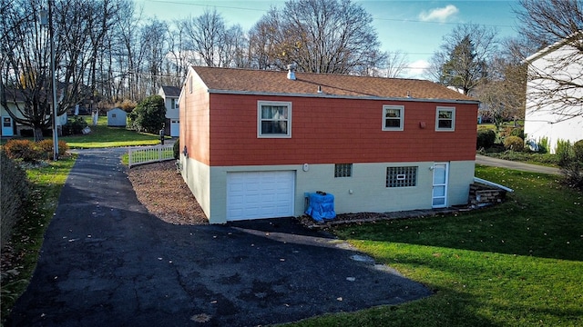 view of side of home with a garage and a yard