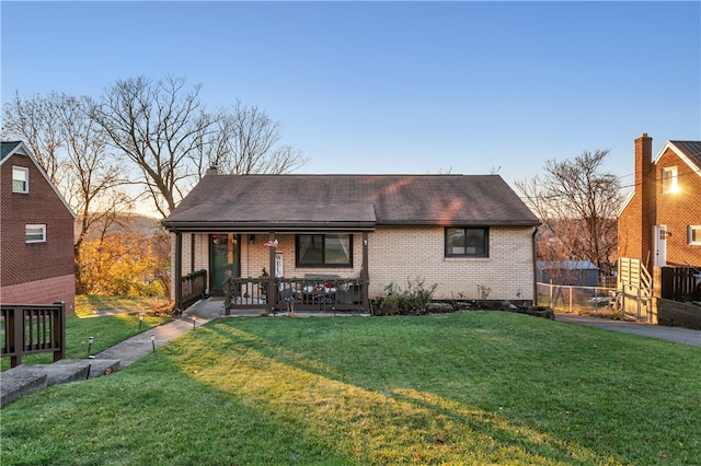 view of front of home with a yard and covered porch