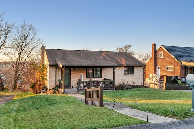 view of front of house with a lawn and a porch