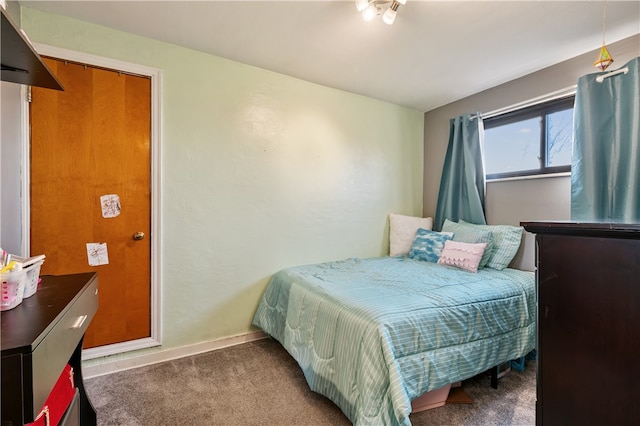 bedroom featuring dark carpet