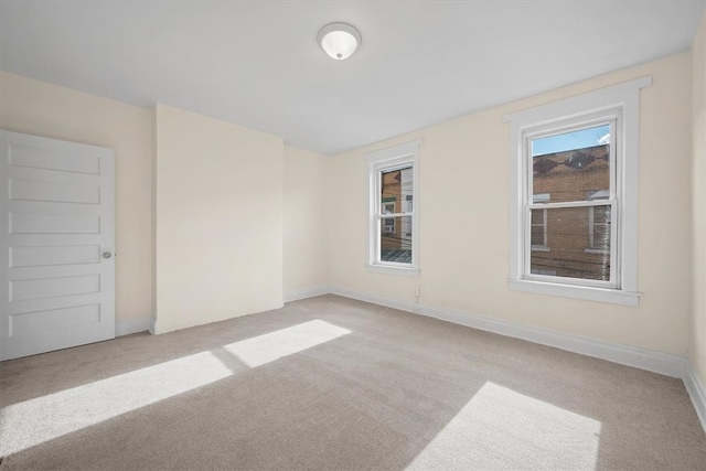 spare room featuring light colored carpet