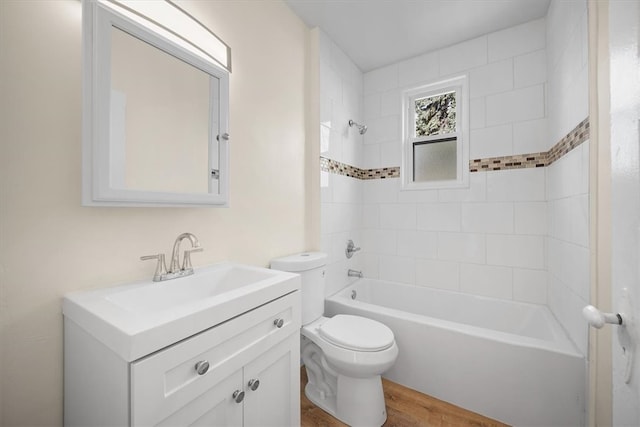 full bathroom featuring vanity, hardwood / wood-style flooring, toilet, and tiled shower / bath